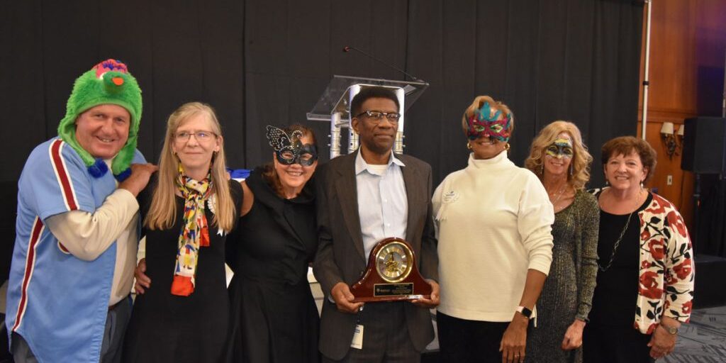 William Harris standing with Sister Grace award winners
